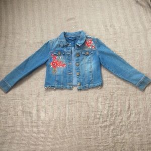 This is a blue jacket with embroidered roses and pearls.
